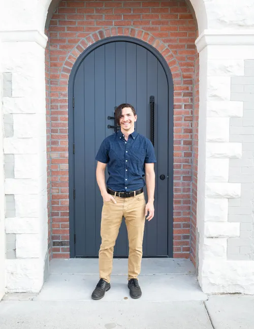 Jacob Tegtman, owner of Third Loft Marketing, standing in an arched doorway